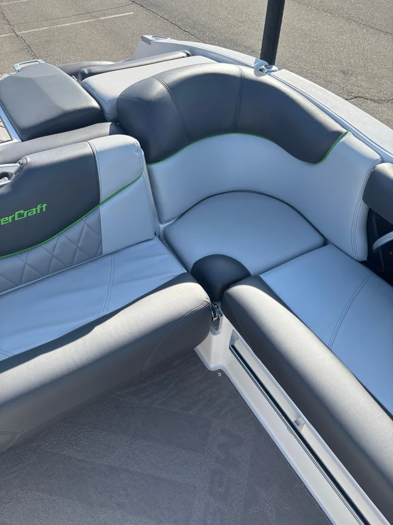 Slide: The Image of 2015 MasterCraft X23 boat interior with gray and black seating. - 11