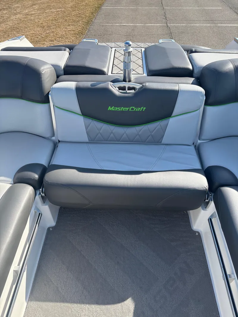 Slide: The Image of 2015 MasterCraft X23 boat interior with gray and black seating. - 12