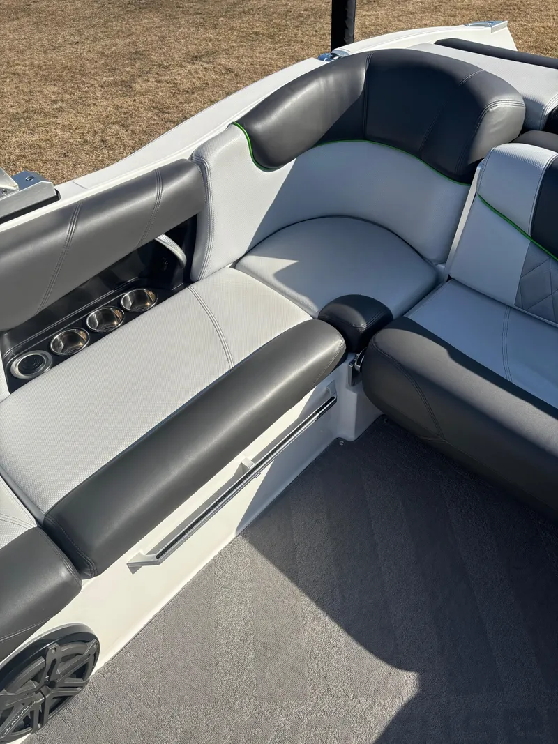 Slide: The Image of 2015 MasterCraft X23 boat interior with gray seating and cup holders. - 13