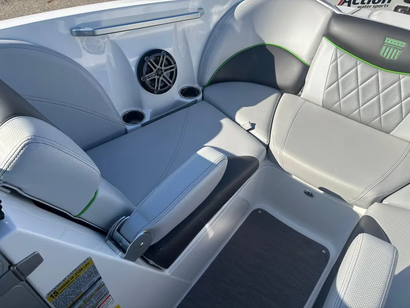 Slide: The Image of 2015 MasterCraft X23 boat interior with gray seating and speaker system. - 18