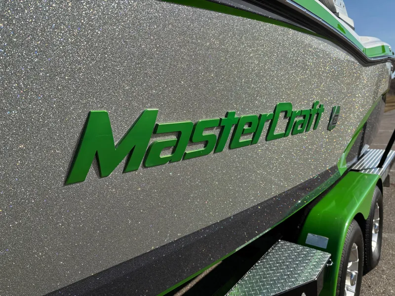 Slide: The Image of 2015 MasterCraft X23 boat with glittery silver and green finish. - 22