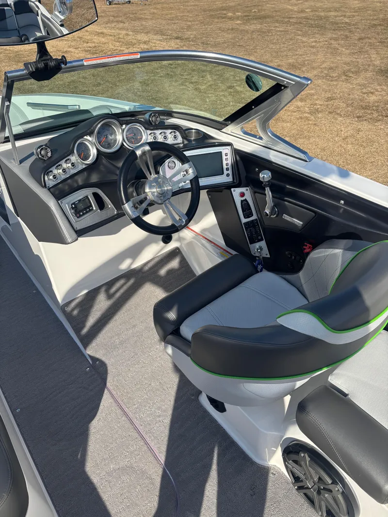 Slide: The Image of 2015 MasterCraft X23 boat interior with modern dashboard and steering wheel. - 7
