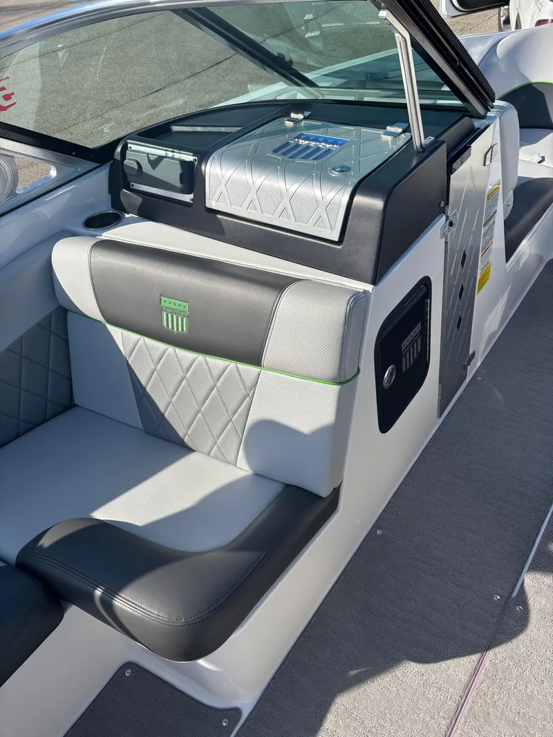 Slide: The Image of 2015 MasterCraft X23 boat interior with gray and black seating, diamond stitching, and control panel. - 8