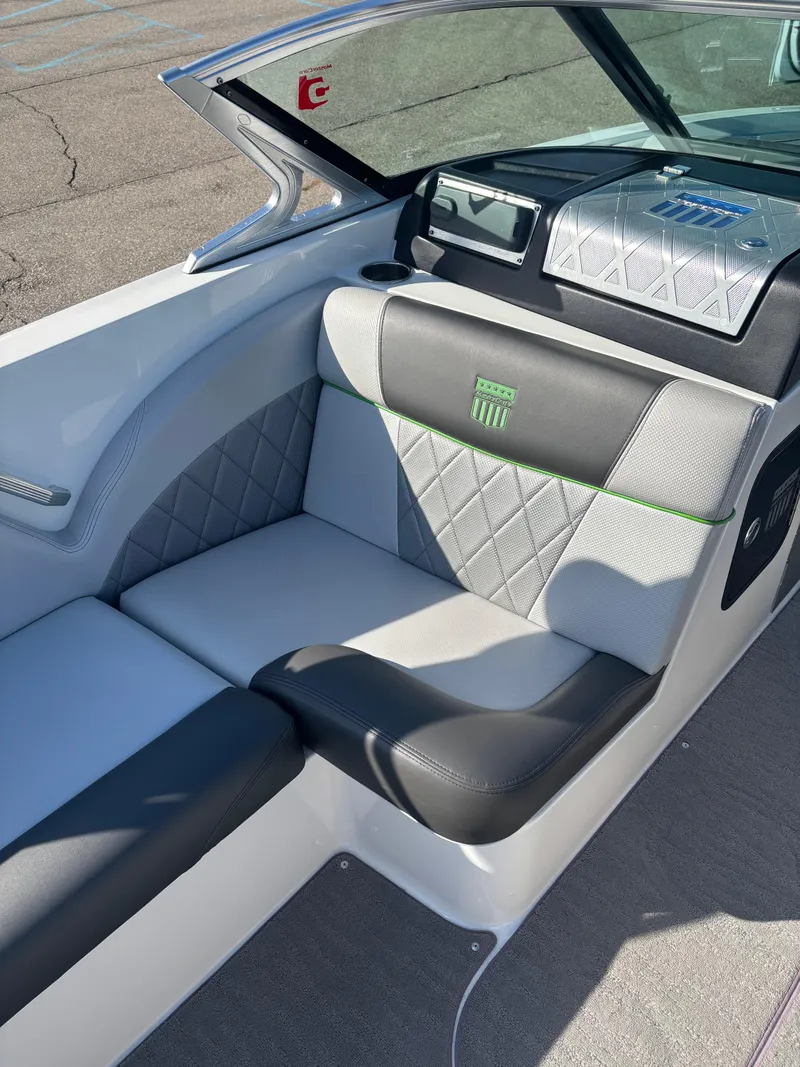 Slide: The Image of 2015 MasterCraft X23 boat interior with gray and black seating, diamond stitching. - 9