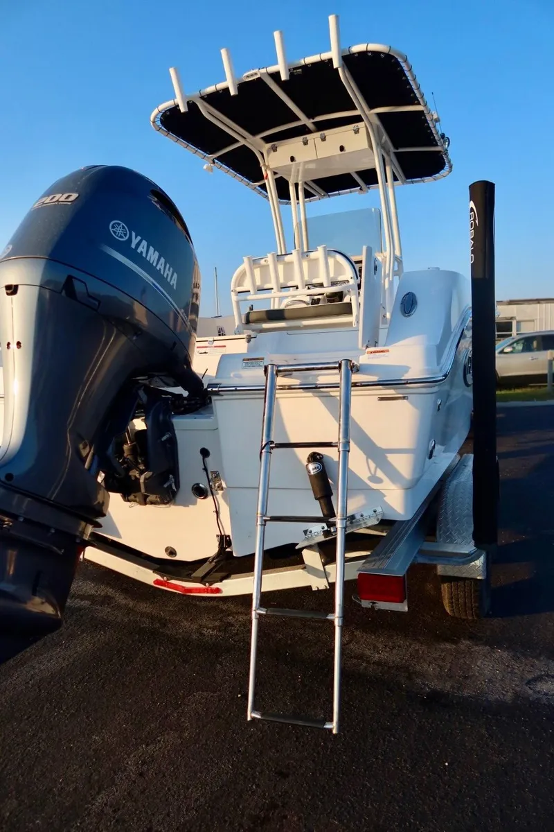 Slide: The Image of 2023 Robalo R200 Center Console boat with Yamaha engine and ladder, parked on trailer. - 3
