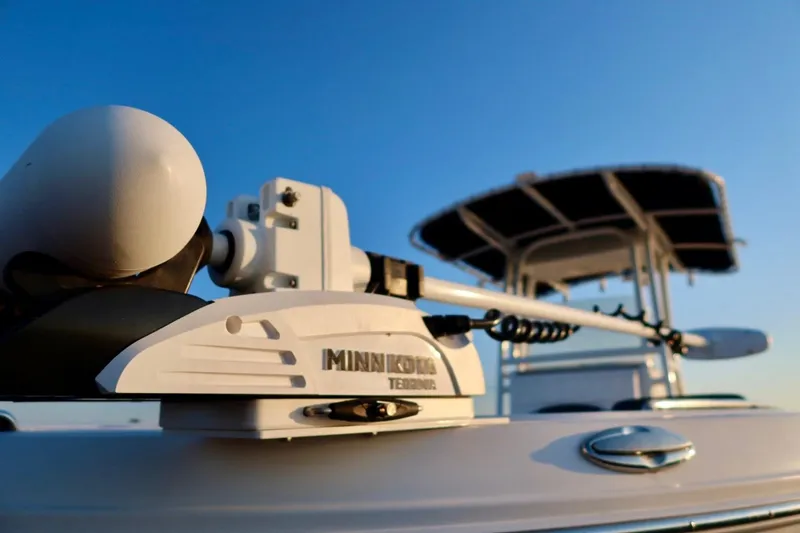 Slide: The Image of 2023 Robalo R200 Center Console boat with Minn Kota trolling motor, clear blue sky background. - 6