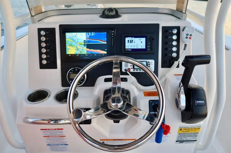 Slide: The Image of 2023 Robalo R200 Center Console dashboard with steering wheel, navigation screens, and controls. - 7