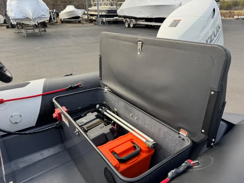 Slide: The Image of 2023 Zodiac Open 4.2 boat storage compartment with equipment and accessories. - 11