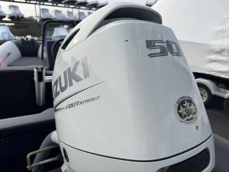 Slide: The Image of 2023 Zodiac Open 4.2 with Suzuki 50HP four-stroke outboard engine, close-up view. - 16