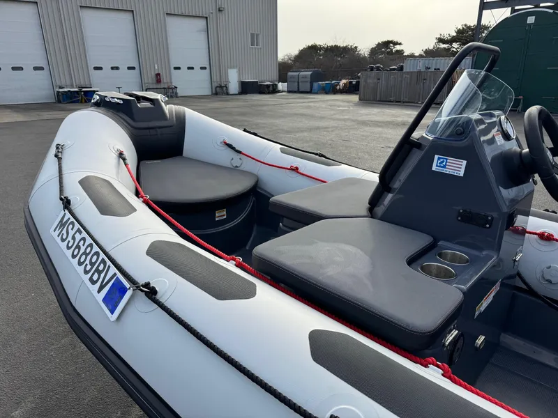 Slide: The Image of 2023 Zodiac Open 4.2 inflatable boat parked near industrial building. - 9