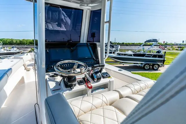 Slide: The Image of 2022 Blue Wave 2800 Makaira boat console with speaker and storage compartment. - 13