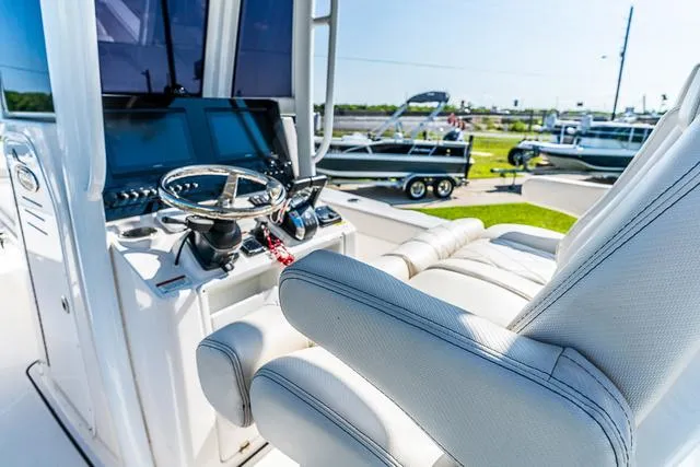 Slide: The Image of Couple dining on 2022 Blue Wave 2800 Makaira boat, enjoying a scenic waterfront view. - 14