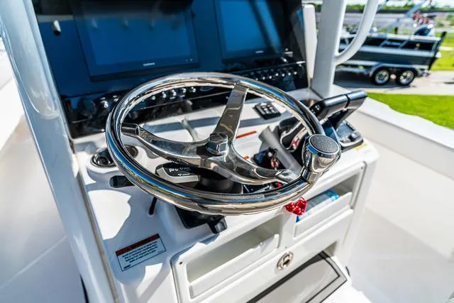 Slide: The Image of Couple relaxing on 2022 Blue Wave 2800 Makaira boat, enjoying a sunny day on the water. - 15