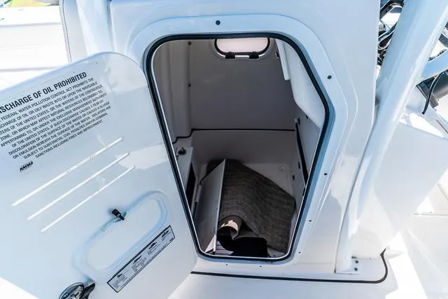 Slide: The Image of 2022 Blue Wave 2800 Makaira boat interior with open storage compartment. - 18