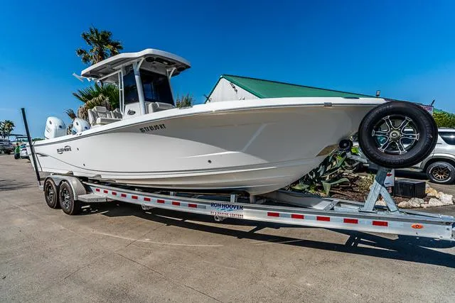 Slide: The Image of 2022 Blue Wave 2800 Makaira boat on open water, featuring spacious seating and sleek design. - 19