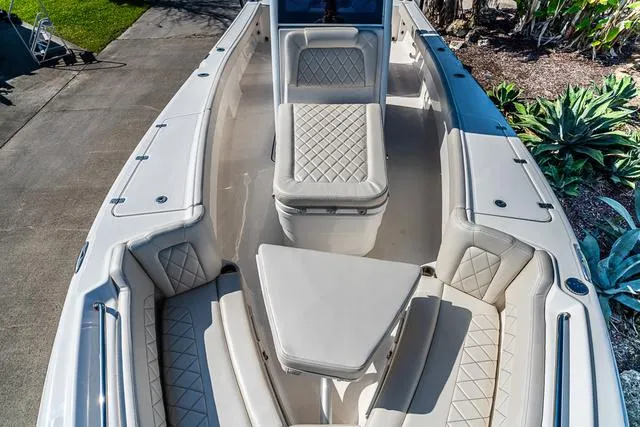 Slide: The Image of 2022 Blue Wave 2800 Makaira boat interior with white seating and storage compartments. - 23