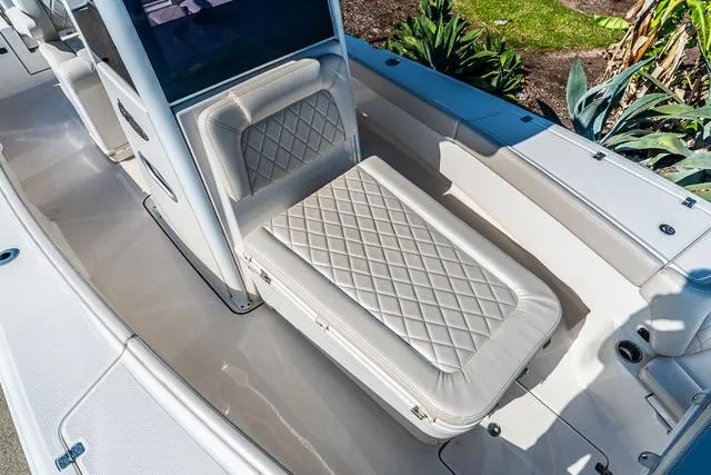 Slide: The Image of 2022 Blue Wave 2800 Makaira boat on water, open storage compartment, sunny day. - 24