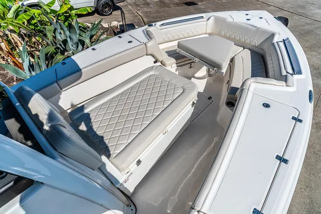 Slide: The Image of 2022 Blue Wave 2800 Makaira boat with open storage compartment and fishing rod. - 25