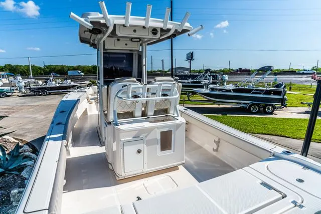 Slide: The Image of 2022 Blue Wave 2800 Makaira boat deck with metal fittings and water in background. - 4