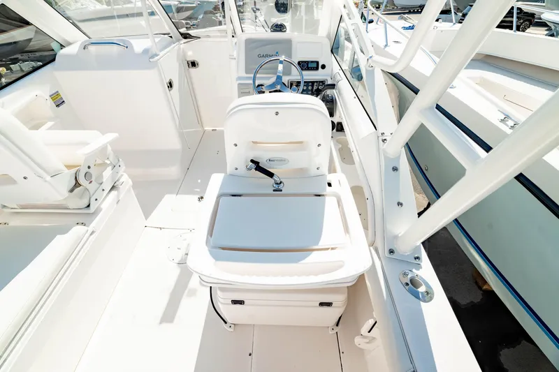 Slide: The Image of 2016 Everglades 230 Dual Console boat interior with seating and steering wheel. - 11