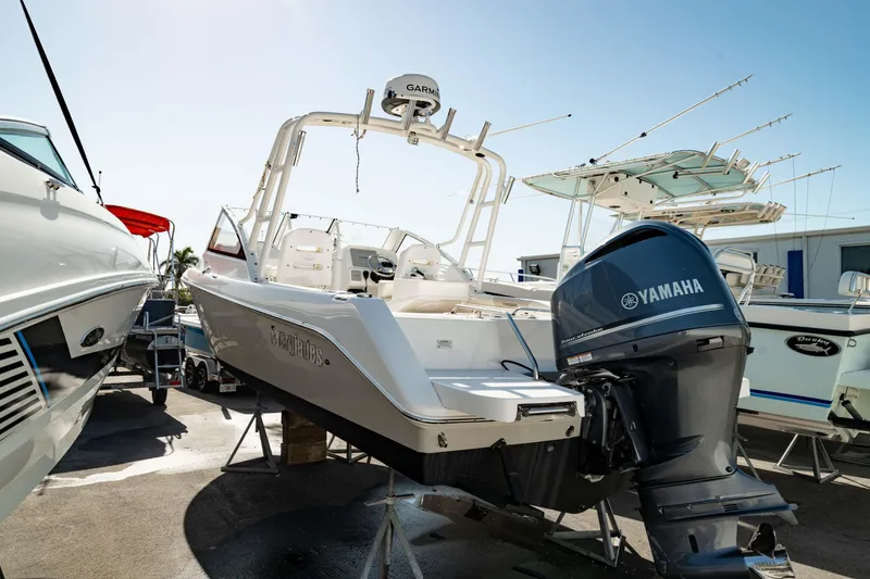 Slide: The Image of 2016 Everglades 230 Dual Console boat with Yamaha engine, docked in a marina. - 13