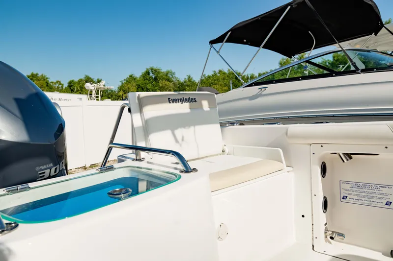 Slide: The Image of 2016 Everglades 230 Dual Console boat interior with seating and storage. - 16