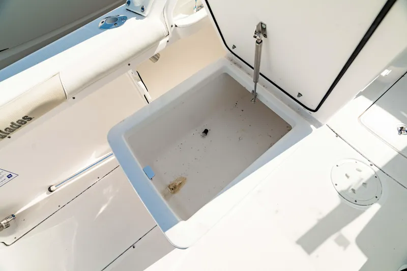 Slide: The Image of Open storage compartment on 2016 Everglades 230 Dual Console boat. - 19