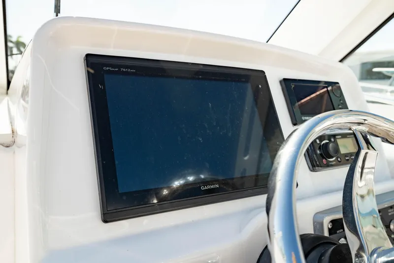 Slide: The Image of Dashboard of 2016 Everglades 230 Dual Console with Garmin display and steering wheel. - 27