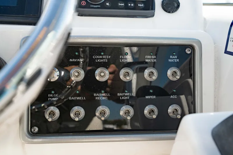 Slide: The Image of Control panel of a 2016 Everglades 230 Dual Console boat with various switches. - 30