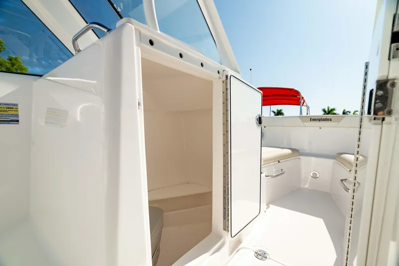 Slide: The Image of 2016 Everglades 230 Dual Console boat interior with open storage compartment. - 32
