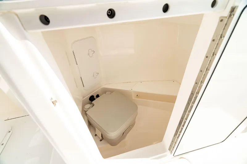 Slide: The Image of Portable toilet inside 2016 Everglades 230 Dual Console boat compartment. - 4