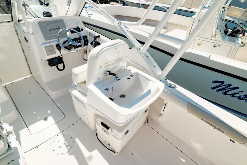 Slide: The Image of 2016 Everglades 230 Dual Console boat interior with steering wheel and seating area. - 6
