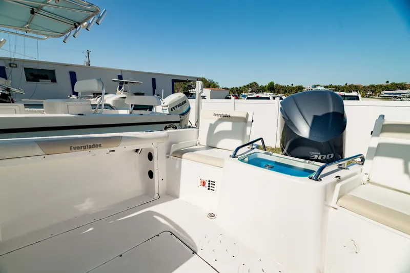 Slide: The Image of 2016 Everglades 230 Dual Console boat with powerful outboard motor, docked under clear blue sky. - 7