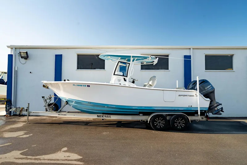 Slide: The Image of 2020 Sportsman Heritage 251 Center Console boat on trailer, parked outdoors. - 0