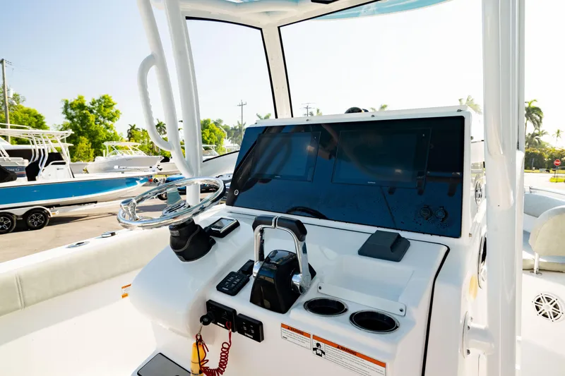 Slide: The Image of 2020 Sportsman Heritage 251 Center Console boat dashboard with steering wheel and controls. - 1