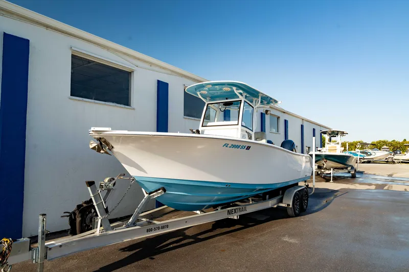 Slide: The Image of 2020 Sportsman Heritage 251 Center Console boat on trailer, parked outdoors. - 21