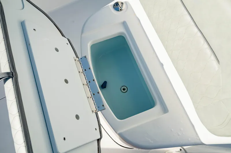 Slide: The Image of 2020 Sportsman Heritage 251 Center Console boat's open storage compartment. - 32