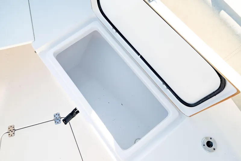 Slide: The Image of Open storage compartment on 2020 Sportsman Heritage 251 Center Console boat. - 35