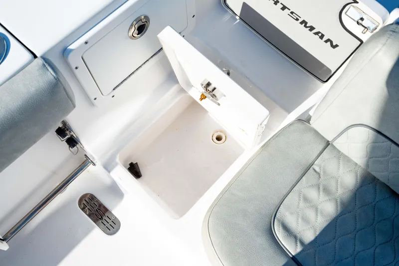 Slide: The Image of 2020 Sportsman Heritage 251 Center Console boat interior with open storage compartment. - 37