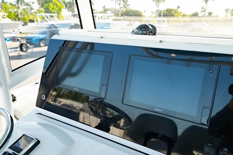 Slide: The Image of 2020 Sportsman Heritage 251 Center Console dashboard with dual Garmin displays. - 4