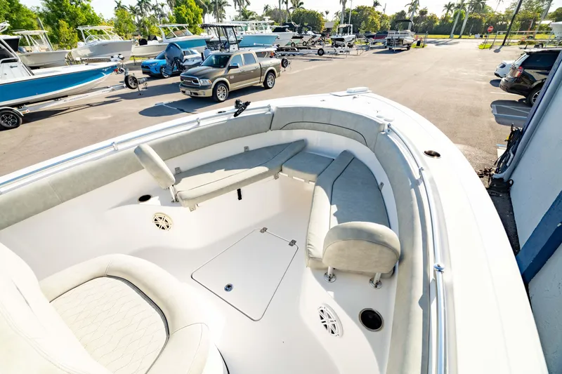 Slide: The Image of 2020 Sportsman Heritage 251 Center Console boat with spacious seating in a sunny marina. - 5