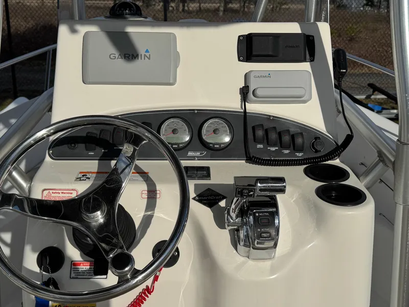 Slide: The Image of 2006 Boston Whaler 210 Outrage boat dashboard with Garmin navigation system and controls. - 10