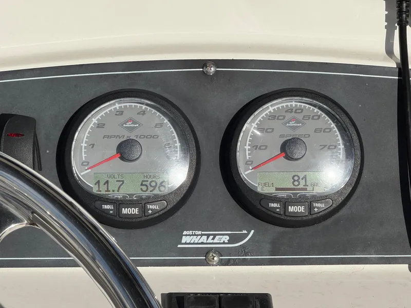 Slide: The Image of Dashboard gauges of a 2006 Boston Whaler 210 Outrage boat, displaying RPM and speed. - 11