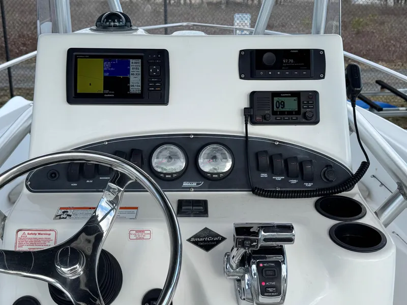 Slide: The Image of Control panel of a 2006 Boston Whaler 210 Outrage boat with navigation instruments. - 12