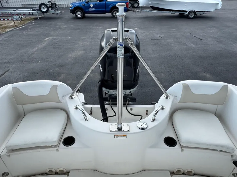 Slide: The Image of 2006 Boston Whaler 210 Outrage boat interior with seating and motor view. - 14