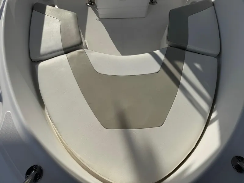Slide: The Image of 2006 Boston Whaler 210 Outrage boat seating area, featuring cushioned seats and sleek design. - 5