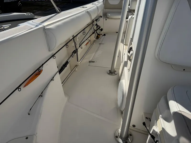 Slide: The Image of 2006 Boston Whaler 210 Outrage interior with rod holders and seating. - 7