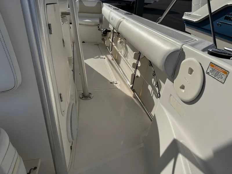 Slide: The Image of 2006 Boston Whaler 210 Outrage interior, featuring seating and storage compartments. - 8