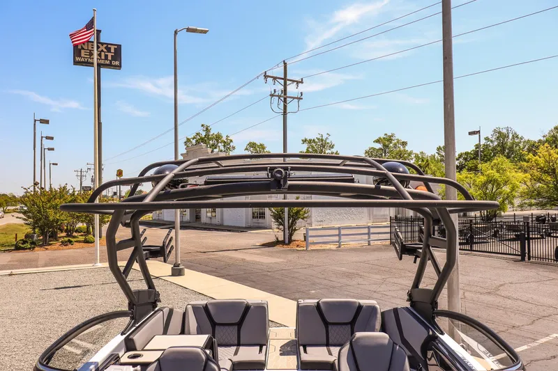 Slide: The Image of 2024 Yamaha Boats 255XD with sleek design, parked outdoors under clear blue sky. - 19