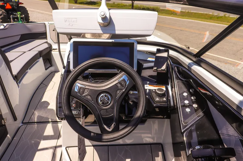 Slide: The Image of 2024 Yamaha Boats 255XD dashboard with steering wheel and modern controls. - 24